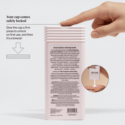 KITSCH Repairing Argan Oil Conditioner packaging callout — Your cap comes safely locked: give the cap a firm press to unlock on first use — hand demonstrating cap-press with unlock diagram — back of bottle showing Smart Solutions Stunning Results claim, Smells Like: Pink Grapefruit, Spun Sugar & Vanilla, and full ingredients list