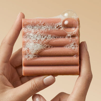 KITSCH Cleansing Amber Shores Body Wash Bar — close-up of bar with rich sudsy lather — Sudsy lather for a soft, luxurious cleanse — easy-grip design features a ridged shape for better handling and application