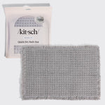 Kitsch Quick-Dry Bath Mat in gray hero image, shown with its retail packaging (non-slip, 1 piece) behind the folded mat.