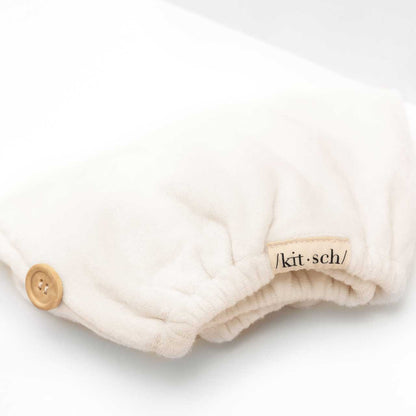 Close-up view of the soft white organic bamboo hair towel fabric highlighting its plush texture.
