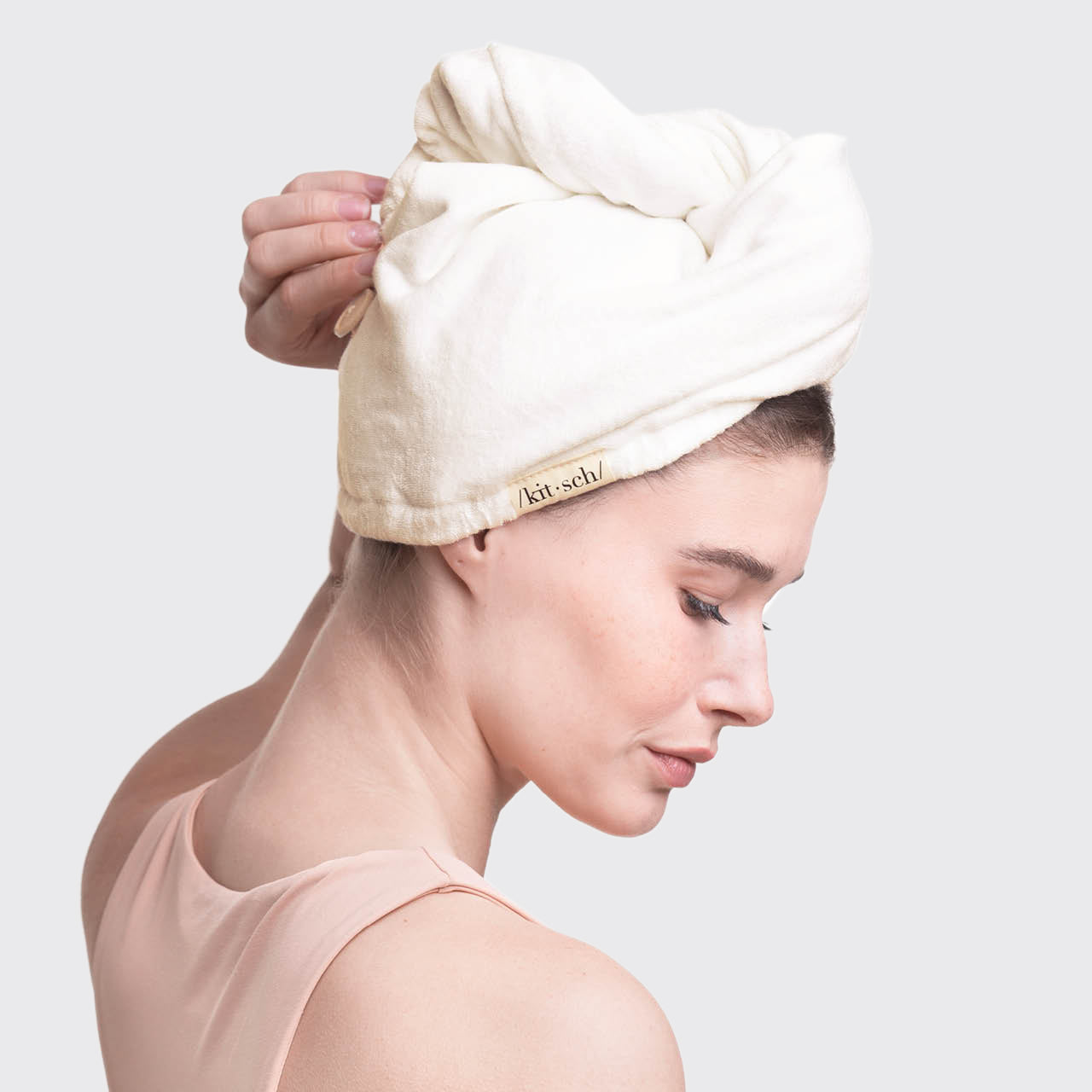 Model wearing a white Organic Bamboo Hair Towel wrap after washing her hair.