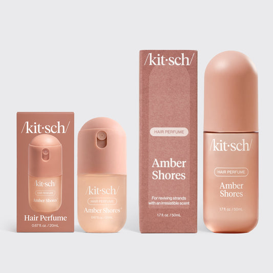 KITSCH Amber Shores Hair & Body Mist + Mini Set — product shot of the full-size 50mL and 20mL mini rose-gold spray bottles side by side — woody aquatic signature scent in two sizes for home and travel