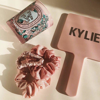 KITSCH Satin Sleep Scrunchies in Blush — lifestyle product shot of blush pink satin sleep scrunchies — silky construction prevents creasing and breakage overnight